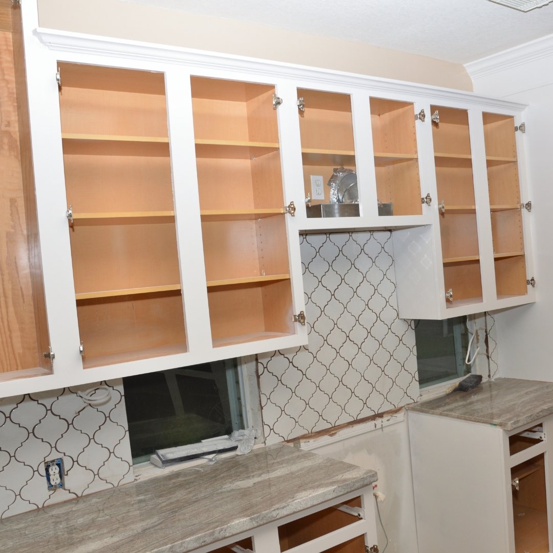 White cabinets with doors removed, ready to be painted.