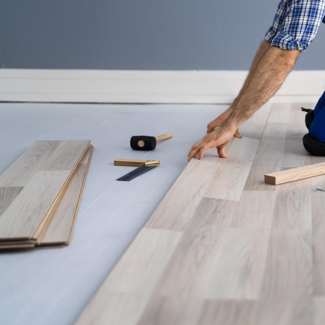 New laminate flooring, half of the room is complete.