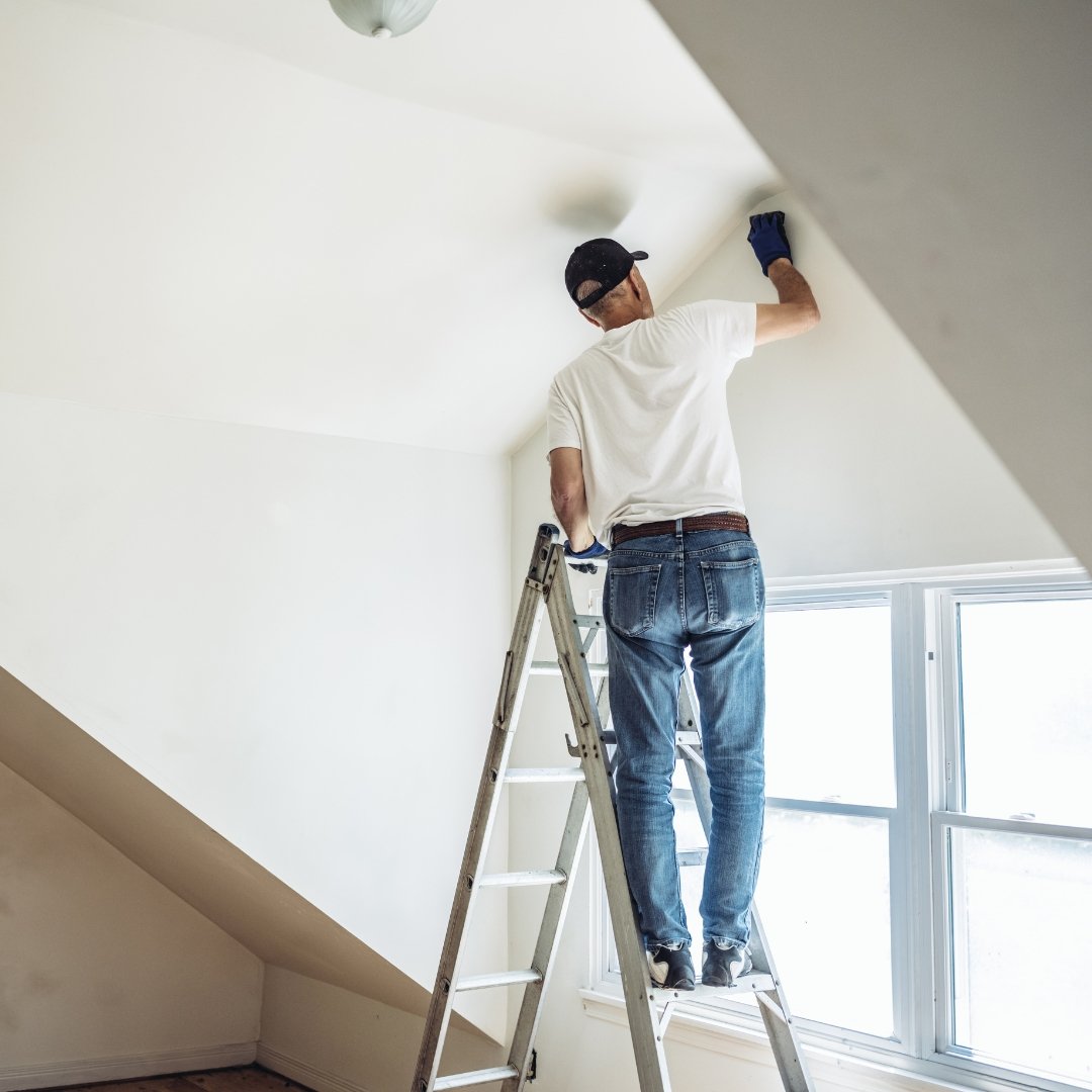 Gentleman painting the interior wall of a home.