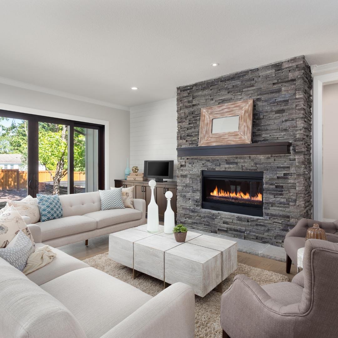 Remodeled living room with fireplace, couch, armchairs, and coffee table by Artisan Painting and Remodeling, serving Portland, OR and Vancouver, WA.