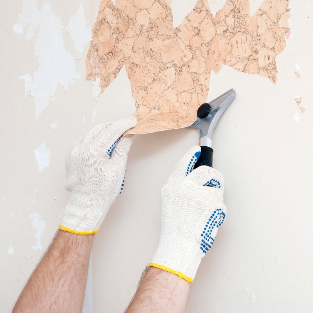 Old wallpaper being scraped off and ready for paint.