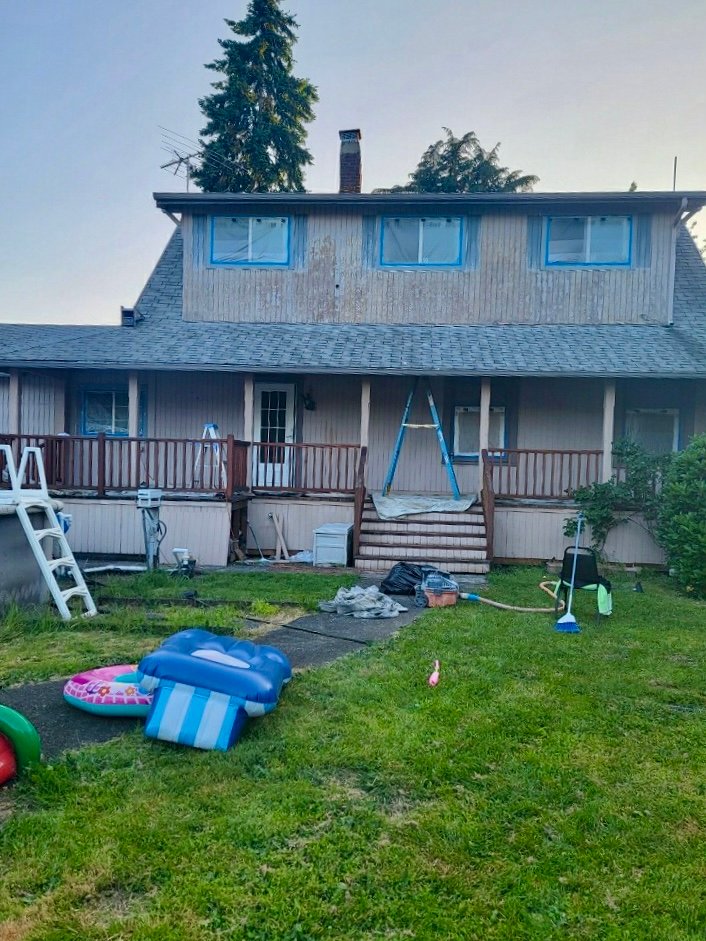 House being painted by professional painters.