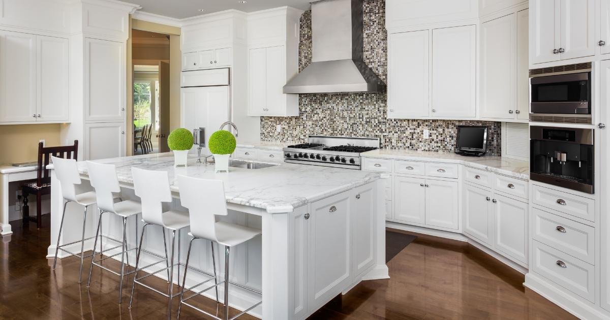 New kitchen remodel in Portland. White counters, white countertops, bar stools in foreground.